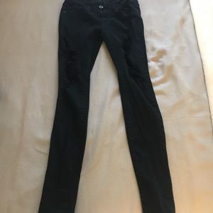 Skinniest black denim jeans with holes